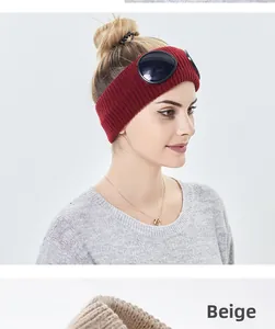 Detail of red and beige knit headbands with integrated aviator goggles for women