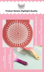 Macro detail of cat ear hairbrush showing the colorful rubber cushion and glitter handle