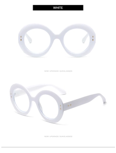 Detailed view of white oversized round glasses frame with gold rivet accents and hinges