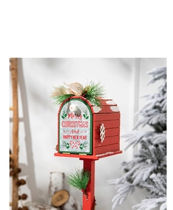 Detailed view of a red Christmas mailbox featuring pine needles, berries and holiday text