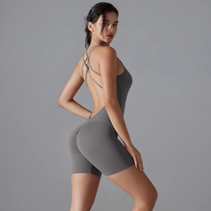 Detail of the cross-back straps and scrunch butt design on a grey yoga bodysuit