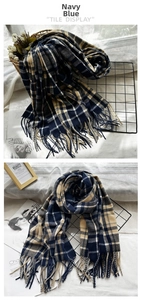 Detailed view of navy blue plaid scarf with fringes and soft cashmere-like texture