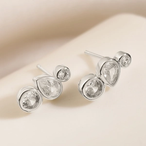 Dainty gold-plated stud earrings featuring pear and round cut cubic zirconia stones
