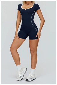 Detail of midnight blue sports romper with white piping and u-neck design for yoga