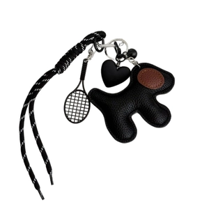 Black leather dog charm keychain with woven lanyard and miniature tennis racket