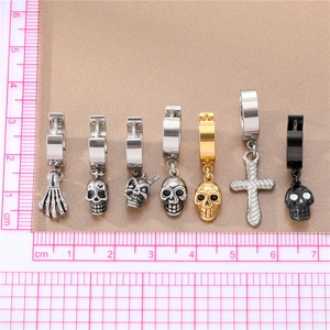 Gothic punk stainless steel hoop earrings with skull and cross charms on a textured base