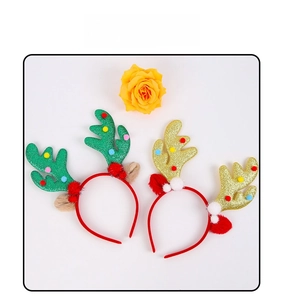 Close-up of glittery Christmas reindeer antlers headbands with colorful pom-poms decor