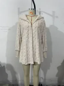 Detail of cream cable-knit hooded cardigan featuring ribbed cuffs and soft fuzzy texture
