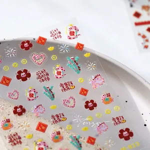Macro view of Chinese New Year nail stickers M-833 featuring red snakes and gold ingots