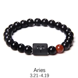Detail of Aries beaded bracelet featuring polished black onyx beads and engraved cylinder