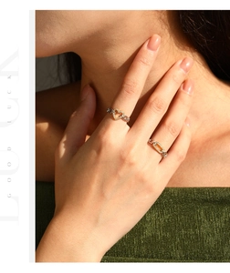 Close-up of gold plated S925 silver rings with heart and chain link diamond settings