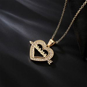 18K gold plated heart necklace with MOM lettering and zircon accents on black background