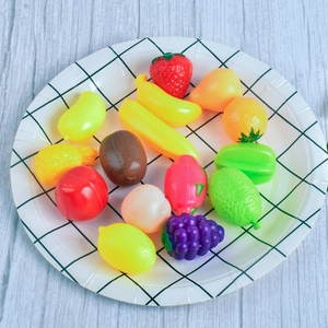 Variety of miniature plastic fruits on a checkered plate for dollhouse scene props