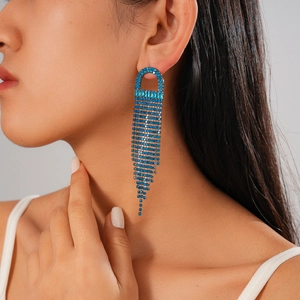 Detail view of blue rhinestone jellyfish tassel earrings worn by a model
