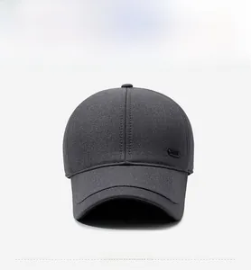 Close-up of a dark grey men's baseball cap with reinforced stitching and metal side logo
