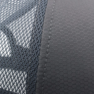 Macro detail of breathable dark gray mesh and honeycomb texture on the quick-dry cap