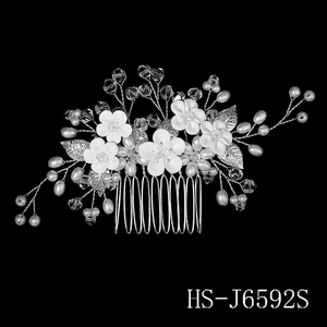 Detail view of silver bridal hair comb with ceramic flowers and sparkling crystals