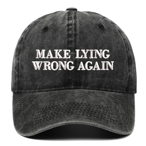 Close-up of white embroidery on a dark gray washed denim baseball cap with slogan