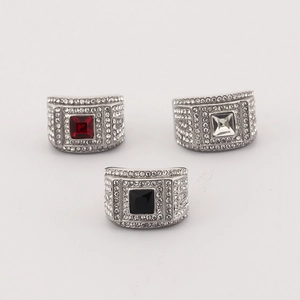 Detailed view of silver stainless steel rings with red black and clear square gemstones