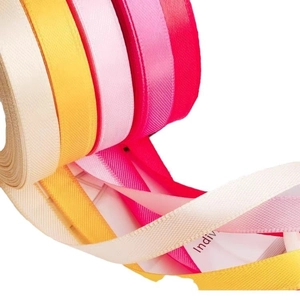 Polyester satin ribbons in cream, yellow and pink for gift wrapping and DIY crafts
