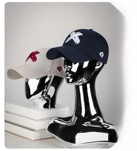 Detail of 3D embroidered baseball cap on a metallic mannequin head display