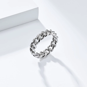 Macro detail of high-polish silver Cuban link chain ring with modern metallic texture