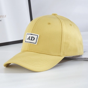 Close-up of bright yellow baseball cap with AD letter embroidery and 6-panel structure