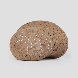 Detailed view of dark brown knitted fisherman hat with hollow geometric crochet patterns