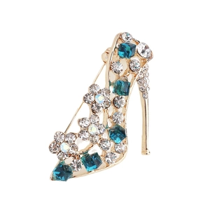 Elegant gold-tone high heel brooch with blue crystals and white floral diamond accents