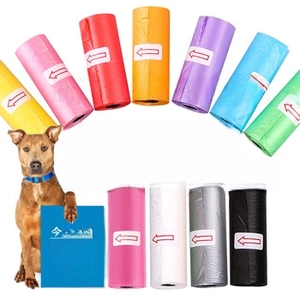 Colorful biodegradable dog poop bags in rolls with directional arrows and a brown dog