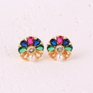 Macro shot of 18K gold plated flower earrings with colorful zircon and pearl center