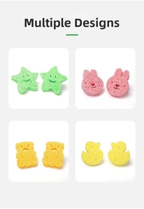 Detailed view of soft wood pulp baby bath sponges in various animal shapes and colors