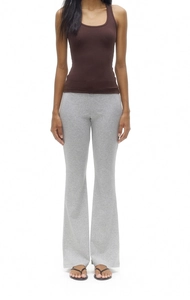 Deep brown racerback tank top paired with grey flared leggings on a standing model