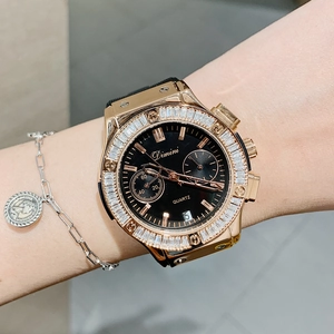 Luxurious gold watch with black dial and crystal bezel worn on a model wrist