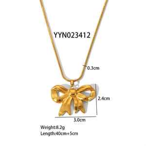 Detail view of a polished gold butterfly pendant with a 0.3cm snake chain and measurements