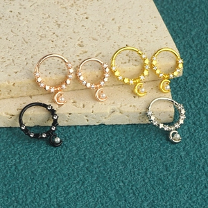 Detail of star and moon nose rings with pearls in rose gold, gold, black and silver