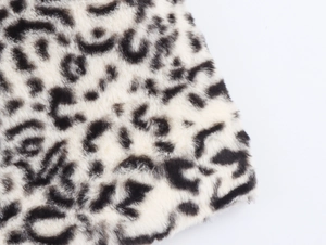 Macro shot of faux fur fabric texture showing soft leopard print plush material