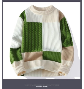 Detailed cable knit texture and color block pattern on a warm crewneck sweater