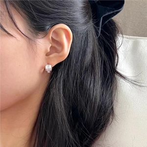 Minimalist 925 sterling silver square hoop earrings with textured finish on model