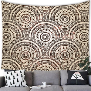 Detail of bohemian mandala tapestry featuring retro brown patterns on a neutral wall