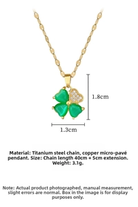 Detail of green clover pendant in gold with sparkling zircon micro-pave and titanium chain