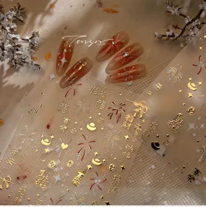 Macro detail of red and gold festive nail stickers with fireworks and lucky characters