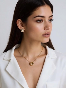 Detailed close-up of 18k gold plated necklace and earring set with crystals on model