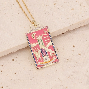 Pink enamel tarot necklace with colorful gemstones on a gold pendant displayed on stone