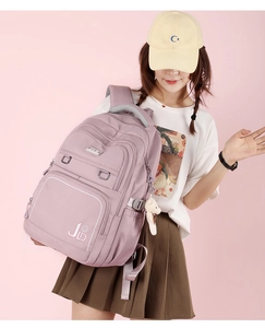 Detail view of large purple waterproof backpack featuring JLD logo and cute bear pendant