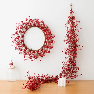 Artificial red berry wreath and matching long vine garland set for Christmas wall decoration