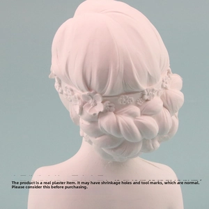 Detail of bust display stand showing intricate braided hair design with floral accents