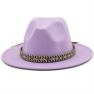 Macro shot of light purple wool fedora with colorful ethnic woven band and leather cords