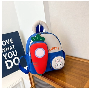 Detail of blue kids backpack with carrot front pocket and bunny pouch on wooden shelf