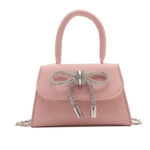 Pink mini crossbody bag with a sparkling rhinestone bow and silver chain strap
